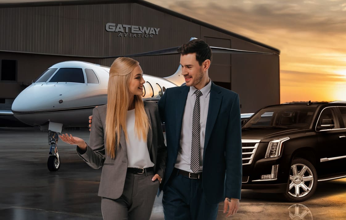 two people wearing suits looking at each other with a plane and suv behind them